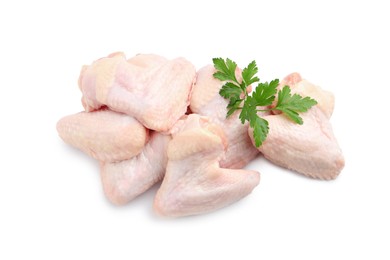 Raw chicken wings with parsley on white background, top view