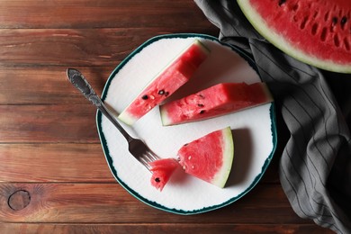Sliced fresh juicy watermelon on wooden table, flat lay