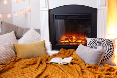 Comfortable place for rest near burning fireplace indoors