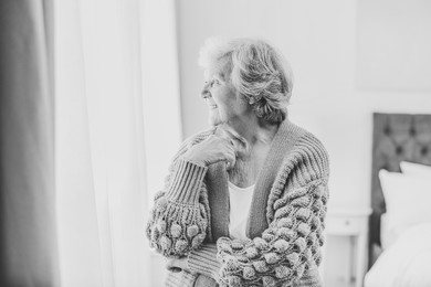 Portrait of beautiful senior woman at home. Black and white photography