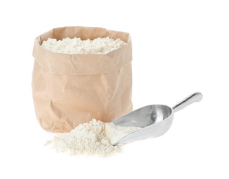 Paper bag and scoop with flour isolated on white
