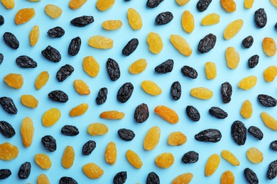 Flat lay composition with raisins on color background. Dried fruit as healthy snack