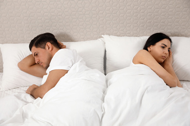 Unhappy couple with relationship problems after quarrel in bed