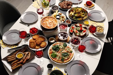 Brunch table setting with different delicious food indoors, above view