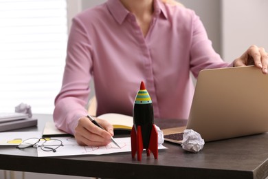 Woman working at messy table, closeup. Startup concept