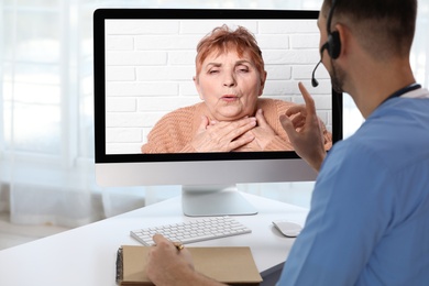 Image of Hotline service. Doctor consulting patient online via computer indoors