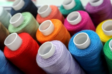 Closeup view of colorful sewing threads as background