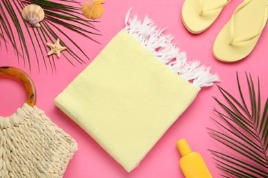 Flat lay composition with different beach objects on pink background
