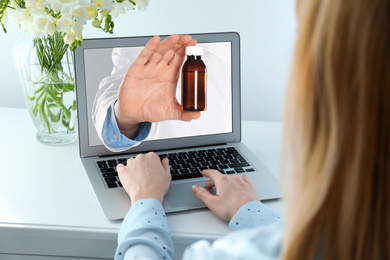 Ordering medications online. Pharmacist giving pills from laptop screen