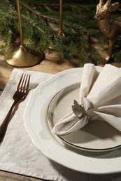 Stylish table setting with white fabric napkin, beautiful decorative ring and festive decor