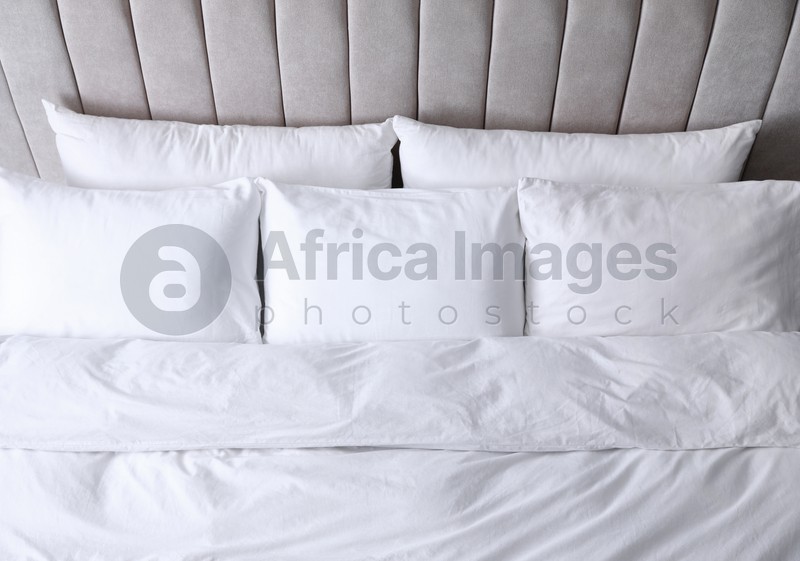 Photo of Comfortable bed with soft pillows, above view