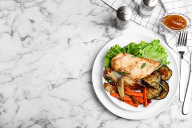 Photo of Delicious cooked chicken and vegetables served on white marble table, flat lay with space for text. Healthy meals from air fryer