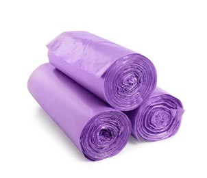 Rolls of violet garbage bags on white background. Cleaning supplies