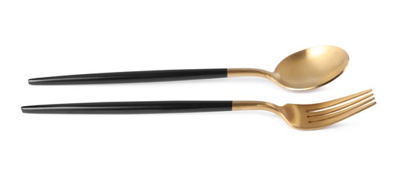 New golden fork and spoon with black handles on white background