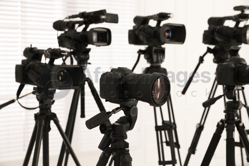 Photo of Modern video cameras indoors. Professional media equipment for broadcasting event