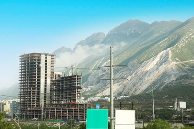 Picturesque landscape with mountains and unfinished building