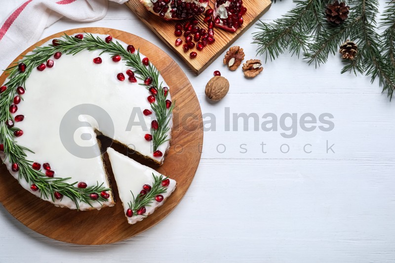 Photo of Flat lay composition with traditional Christmas cake on white wooden table. Space for text