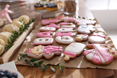 Baby shower party. Delicious cookies on wooden table indoors, closeup