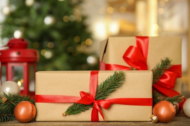 Beautiful gift boxes and Christmas decor on wooden table, closeup
