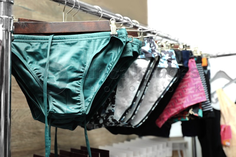 Different male underwear on hangers in boutique