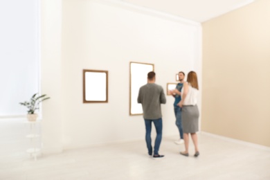 People in modern art gallery, blurred view