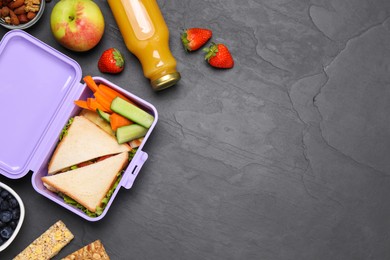 Flat lay composition with lunch box and tasty healthy food on grey table., space for text. School dinner