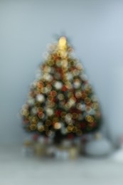 Blurred view of beautifully decorated Christmas tree in room