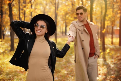 Lovely couple walking in park on autumn day