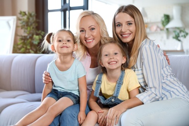 Little girls with their mother and granny in living room