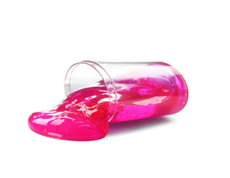 Photo of Overturned plastic container with magenta slime isolated on white. Antistress toy
