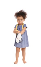 Cute African American child imagining herself as doctor while wearing rubber glove on white background