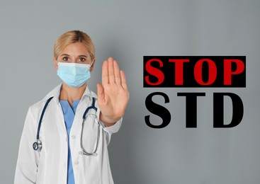 STD prevention. Doctor in protective mask showing stop gesture on grey background