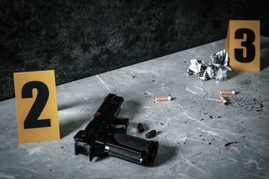 Crime scene markers and evidences on light grey marble table