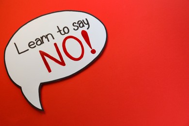 Photo of Paper speech bubble with phrase Learn to Say No on red background, top view. Space for text