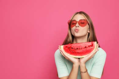 Beautiful girl with slice of watermelon on crimson background. Space for text