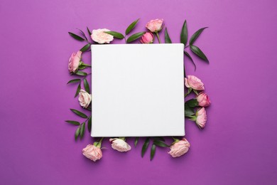Photo of Flat lay composition with blank canvas and beautiful roses on purple background. Mockup for design