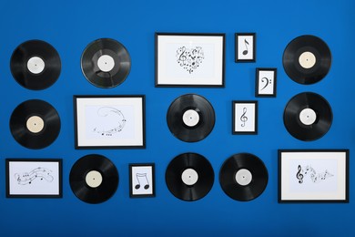 Vinyl records and different pictures on blue background