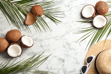 Flat lay composition with coconuts and space for text on marble background