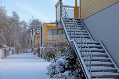 Photo of House with ladder and trees in winter morning