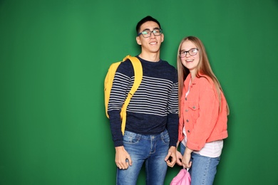 Cheerful teenagers on color background, space for text. Youth lifestyle and friendship