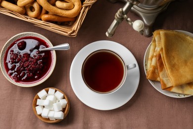 Photo of Flat lay composition with aromatic tea and treats on table