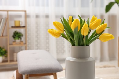 Photo of Spring interior. Bouquet of beautiful yellow tulips in living room, space for text