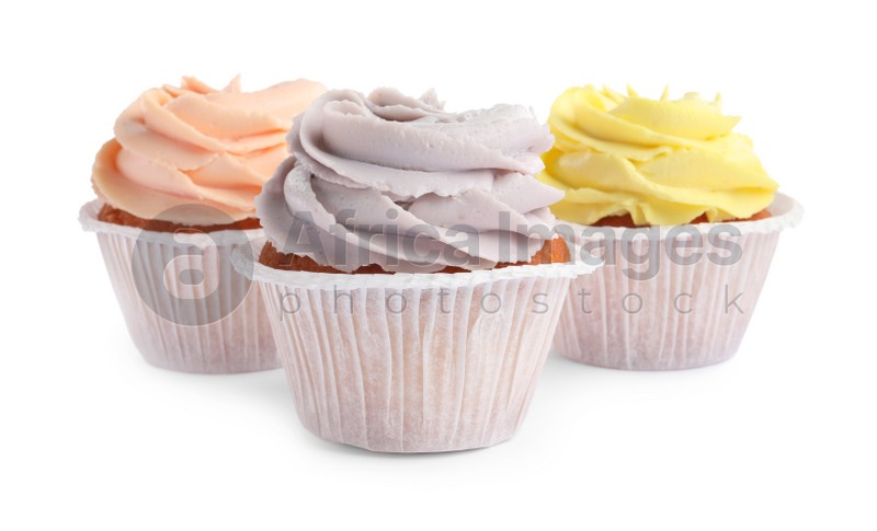 Photo of Tasty cupcakes with cream isolated on white