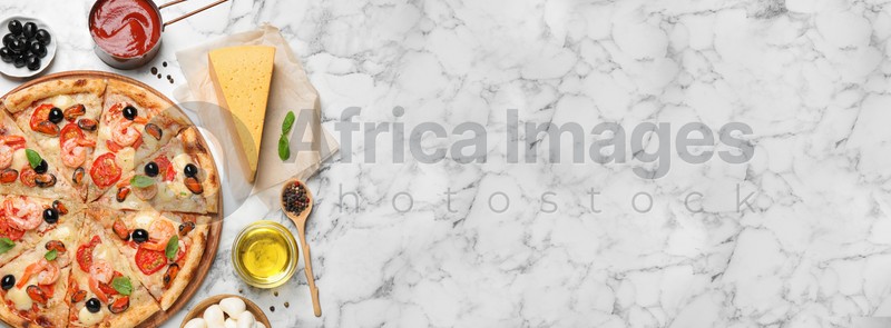 Tasty seafood pizza and ingredients on white marble table, flat lay with space for text. Banner design