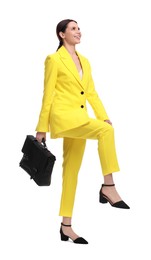 Photo of Beautiful businesswoman in yellow suit with briefcase posing on white background