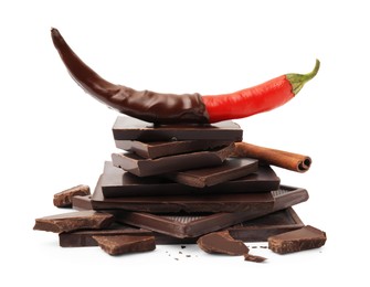 Photo of Red hot chili pepper and dark chocolate with cinnamon isolated on white