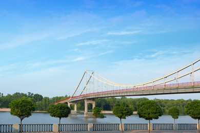 KYIV, UKRAINE - AUGUST 11, 2022: Beautiful cityscape with pedestrian Park bridge over Dnipro river