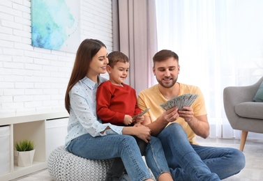 Happy family with money at home. Financial planning