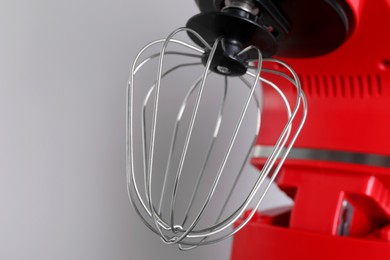 Modern red stand mixer on light gray background, closeup
