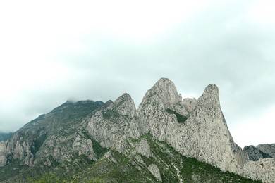 Picturesque landscape with high mountains under gloomy sky